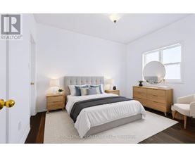 A bedroom with a bed, nightstands, and a chair.