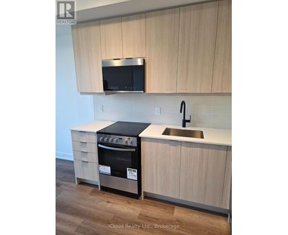 A kitchen with a stove and microwave above it.