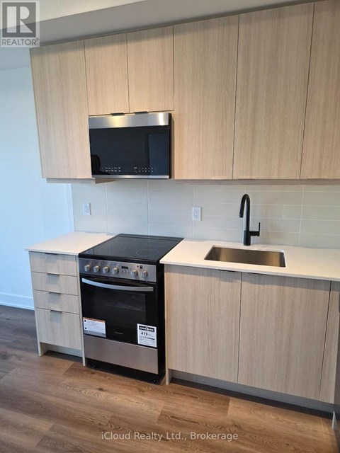 A kitchen with a stove and microwave above it.