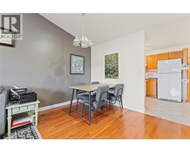 A dining room with a table and chairs.
