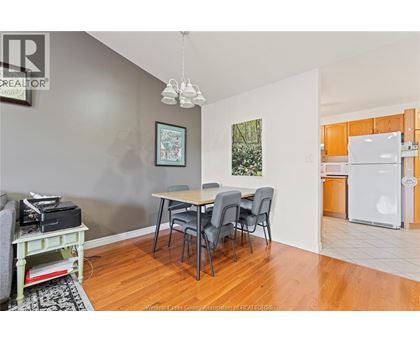 A dining room with a table and chairs.