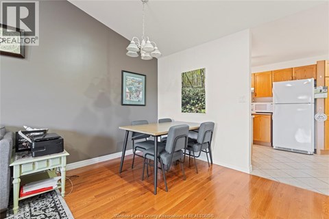 A dining room with a table and chairs.