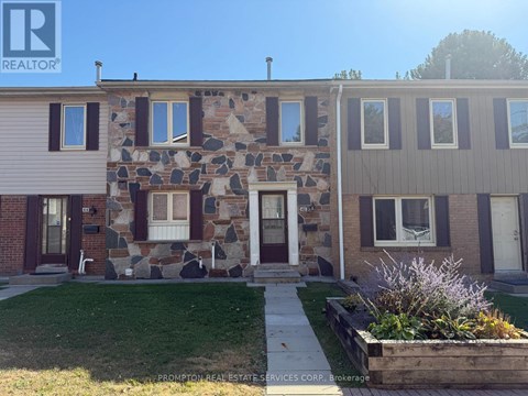 A stone wall is part of a house's facade.