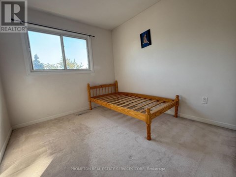 A bedroom with a bed and a window.