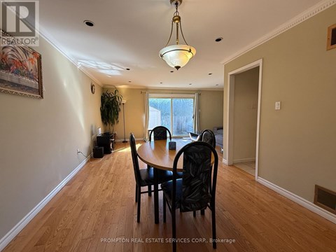 A dining room with a table and chairs.
