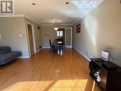 A living room with a grey sofa and wooden floors.