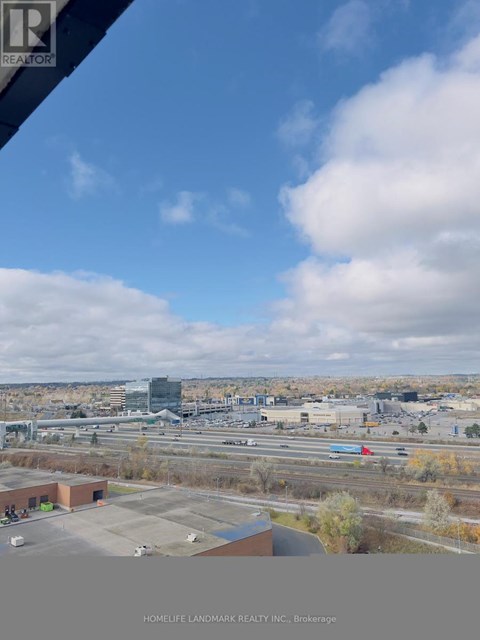 A view from a window of a cityscape with buildings and a highway.