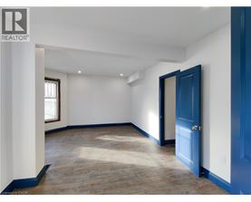 A room with a blue door and a window.