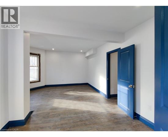 A room with a blue door and a window.
