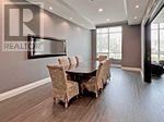 A dining room with a table and chairs.