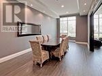A dining room with a table and chairs.
