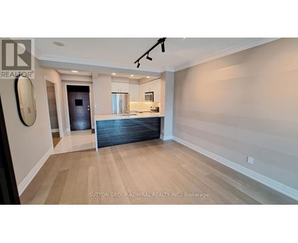 A spacious room with a pool table and a bar area.