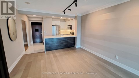 A spacious room with a pool table and a bar area.