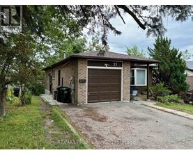 A house with a brown garage door is number 77.