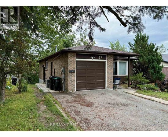 A house with a brown garage door is number 77.