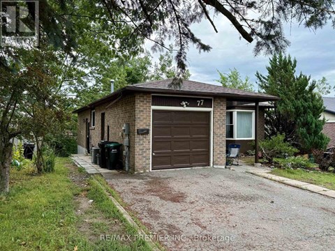 A house with a brown garage door is number 77.