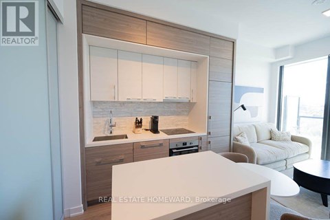 A modern kitchen with wooden cabinets and a white island.