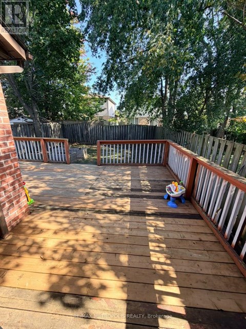 A wooden deck with a child's toy on it.
