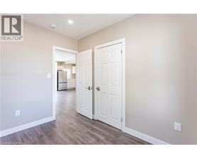 A room with a white door and a wall with a logo that says REALTOR.
