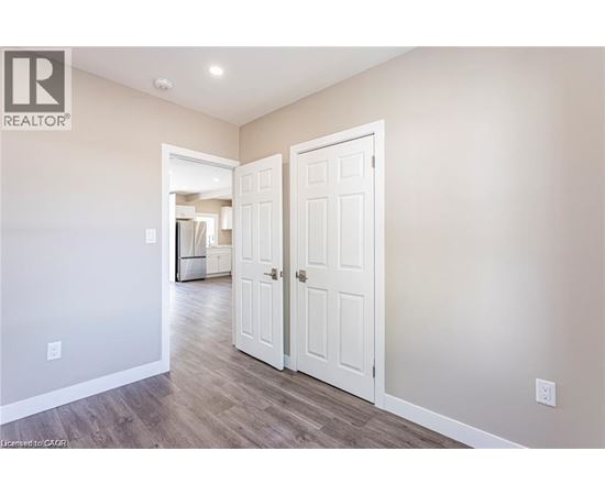 A room with a white door and a wall with a logo that says REALTOR.