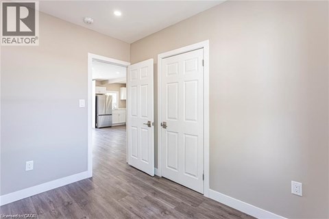 A room with a white door and a wall with a logo that says REALTOR.