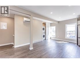 A spacious room with a washer and dryer in it.