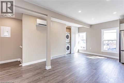 A spacious room with a washer and dryer in it.