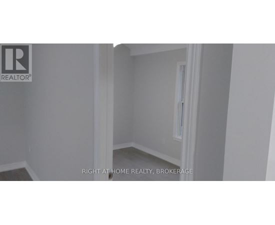 A room with a white door and a window.