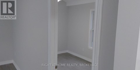 A room with a white door and a window.