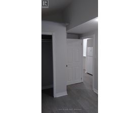 A white door is in a room with grey walls.