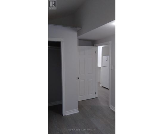 A white door is in a room with grey walls.