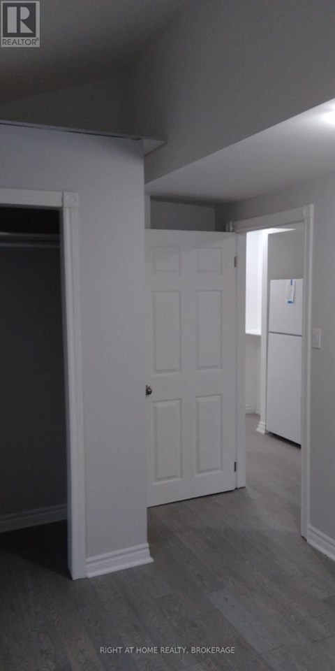A white door is in a room with grey walls.