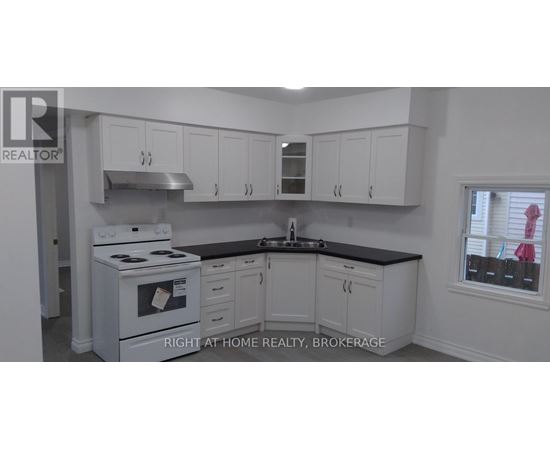 A white stove and cabinets in a kitchen.