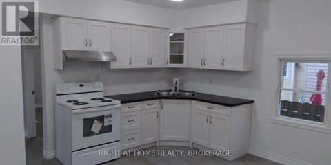A white stove and cabinets in a kitchen.