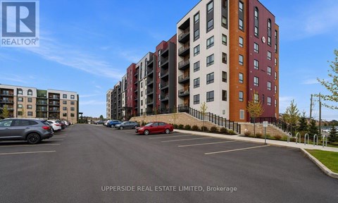 A parking lot with cars and apartment buildings in the background.