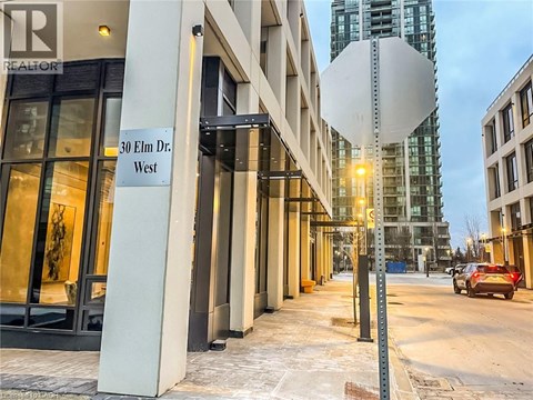 A street view of 30 Elm Dr. West with a car parked on the side of the road.