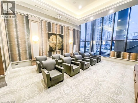 A living room with grey couches and a large window.