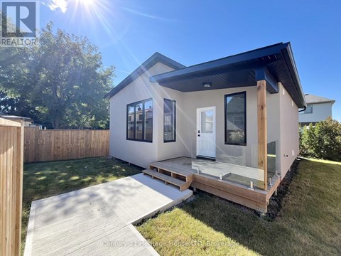 A modern house with a wooden deck and a glass door.