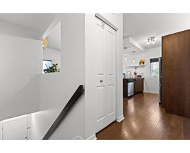 A white interior with a brown floor and a white door.