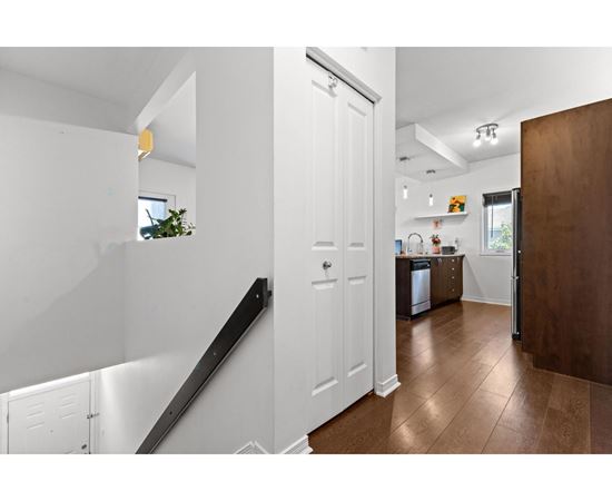 A white interior with a brown floor and a white door.