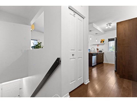 A white interior with a brown floor and a white door.