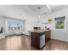 A modern kitchen with a wooden island and stainless steel appliances.