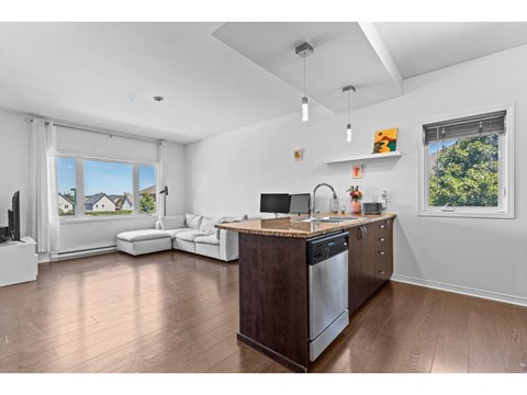 A modern kitchen with a wooden island and stainless steel appliances.