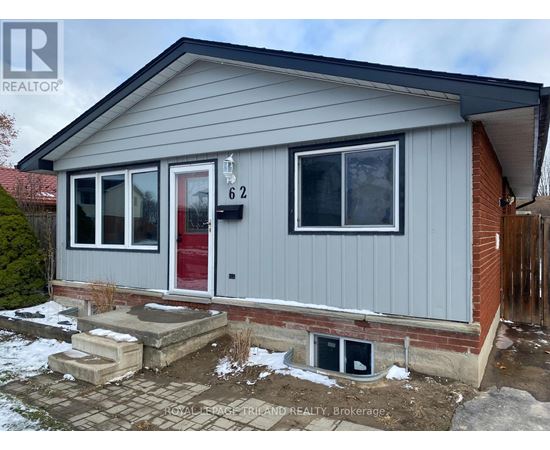 A grey house with a red door and a number 62 on it.