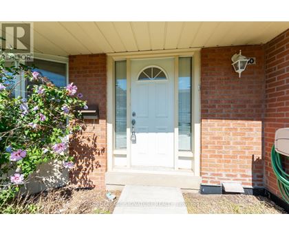 A white door is on the front of a brick house.