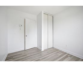A room with a white door and a white wall.
