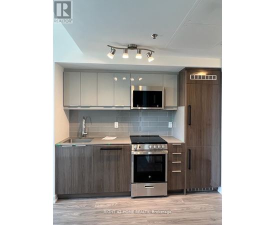 A modern kitchen with a stainless steel oven and microwave.