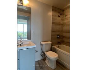 A bathroom with a toilet, sink, and bathtub.