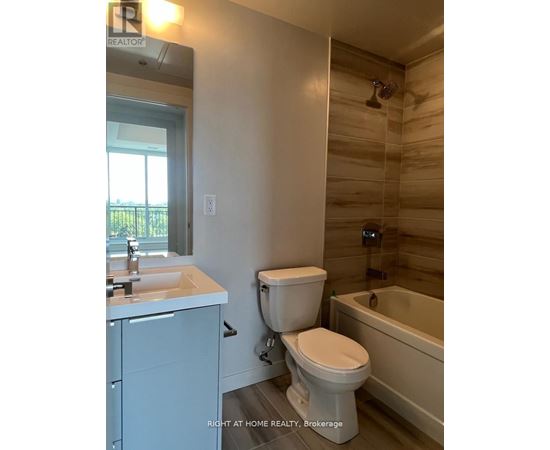 A bathroom with a toilet, sink, and bathtub.