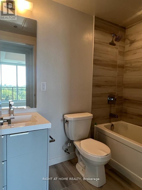 A bathroom with a toilet, sink, and bathtub.